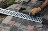 Installation of light metal grating and gutters for drainage of rainwater and paving slabs
