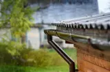 Rain flows down from the roof into a gutter
